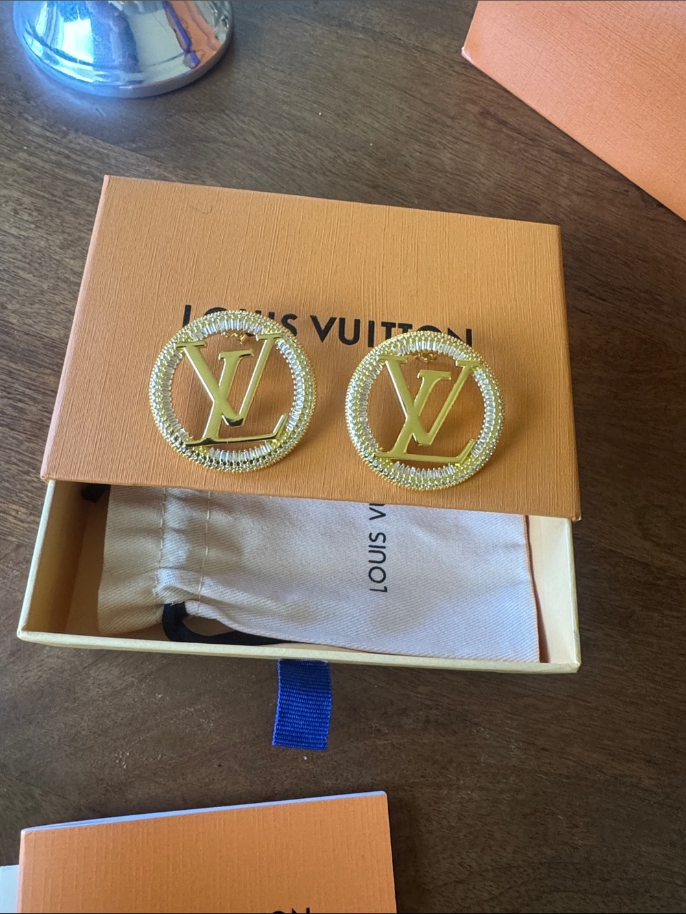 Gold-colored hoop earrings with butterfly clasps